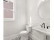 Stylish powder room with pedestal sink and patterned floor at 1005 Coleman Place Dr, Roswell, GA 30075