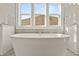 Elegant bathroom featuring a freestanding bathtub and large windows at 1005 Coleman Place Dr, Roswell, GA 30075