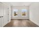 Bright bedroom with hardwood floors and two windows at 1005 Coleman Place Dr, Roswell, GA 30075