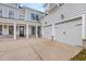 Three-car garage with light gray doors and a spacious driveway at 1005 Coleman Place Dr, Roswell, GA 30075