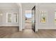 Open entryway with hardwood floors, a view of the street, and a black front door at 1005 Coleman Place Dr, Roswell, GA 30075