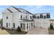 Two-story house with gray siding, a metal roof, and a three-car garage at 1005 Coleman Place Dr, Roswell, GA 30075