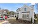 Two-story house with gray siding, brick accents, and a three-car garage at 1005 Coleman Place Dr, Roswell, GA 30075