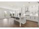 Modern white kitchen with large island and stainless steel appliances at 1005 Coleman Place Dr, Roswell, GA 30075