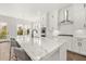 Modern white kitchen with large island and quartz countertops at 1005 Coleman Place Dr, Roswell, GA 30075