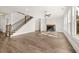 Sunlit living room with hardwood floors and fireplace at 1005 Coleman Place Dr, Roswell, GA 30075