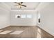 Main bedroom with hardwood floors, tray ceiling and large windows at 1005 Coleman Place Dr, Roswell, GA 30075