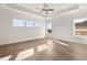 Spacious main bedroom with hardwood floors, ceiling fan and large windows at 1005 Coleman Place Dr, Roswell, GA 30075