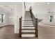 Elegant staircase with dark wood railings and white risers at 1005 Coleman Place Dr, Roswell, GA 30075