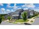 Aerial view of homes with gray and white exteriors, landscaping, and a curved street at 1010 Coleman Place Dr, Roswell, GA 30075