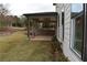 Covered patio with brick wall and grassy yard at 1010 Coleman Place Dr, Roswell, GA 30075