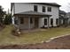 Covered patio with concrete flooring and a grassy backyard at 1010 Coleman Place Dr, Roswell, GA 30075