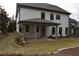 Covered patio with brick retaining wall and grassy backyard at 1010 Coleman Place Dr, Roswell, GA 30075