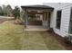 Covered patio with brick retaining wall and grassy backyard at 1010 Coleman Place Dr, Roswell, GA 30075