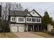 Two-story house with gray shutters, a metal roof, and a double-car garage at 1010 Coleman Place Dr, Roswell, GA 30075