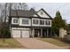 Two-story home with gray siding, dark shutters, and a three-car garage at 1010 Coleman Place Dr, Roswell, GA 30075