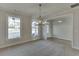 Bright dining room with chandelier and views of entryway and windows at 2870 S Waterworks Rd, Buford, GA 30518