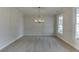 Spacious dining room with carpet, chandelier, and large windows at 2870 S Waterworks Rd, Buford, GA 30518