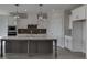 Modern kitchen with white cabinets, large island, and gray lower cabinets at 2870 S Waterworks Rd, Buford, GA 30518