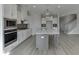 Modern kitchen with island, stainless steel appliances, and white cabinetry at 2870 S Waterworks Rd, Buford, GA 30518