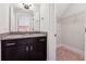 Bathroom with dark vanity, granite countertop and walk-in closet at 320 Discovery Lake Dr, Fayetteville, GA 30215