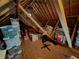 Unfinished attic space filled with various stored goods, and wooden beams at 992 Bridgegate Ne Dr, Marietta, GA 30068