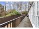 Long back deck overlooking fenced in backyard with patio and string lights at 992 Bridgegate Ne Dr, Marietta, GA 30068