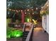 Inviting backyard deck with string lights, patio furniture, and red umbrella at 992 Bridgegate Ne Dr, Marietta, GA 30068