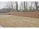 Backyard with newly installed sod and a view of trees at 699 Sunstone Ln, Lawrenceville, GA 30043