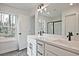 Bathroom featuring a double sink vanity, black faucets and hardware and outside view window at 699 Sunstone Ln, Lawrenceville, GA 30043