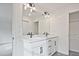 Elegant bathroom with double vanity, black hardware, and stylish lighting at 699 Sunstone Ln, Lawrenceville, GA 30043