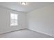 Bright bedroom with a window allowing natural light and neutral colored carpet at 699 Sunstone Ln, Lawrenceville, GA 30043