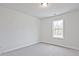 Bright bedroom with a window allowing natural light and neutral colored carpet at 699 Sunstone Ln, Lawrenceville, GA 30043