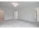 Large bedroom with neutral carpet, white walls, and walk-in closet access at 699 Sunstone Ln, Lawrenceville, GA 30043