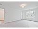 Cozy bedroom with plush carpeting, a ceiling light, and a view of trees at 699 Sunstone Ln, Lawrenceville, GA 30043