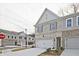 Attractive townhome exterior featuring a brick facade, gray siding, and attached garage at 699 Sunstone Ln, Lawrenceville, GA 30043