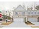 Charming townhouse with a white brick facade, two-car garage, and well-manicured lawn at 699 Sunstone Ln, Lawrenceville, GA 30043