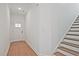 Bright foyer featuring hardwood floors and a staircase leading to the upper level at 699 Sunstone Ln, Lawrenceville, GA 30043