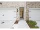 Inviting townhome entrance with a two-car garage and a view into the bright interior at 699 Sunstone Ln, Lawrenceville, GA 30043