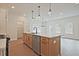 Elegant kitchen island featuring stainless steel appliances, ample storage, and stylish pendant lighting at 699 Sunstone Ln, Lawrenceville, GA 30043