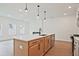 Open-concept kitchen island with seating, stainless steel appliances, and modern lighting perfect for entertaining at 699 Sunstone Ln, Lawrenceville, GA 30043