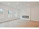 Modern living room featuring an electric fireplace, recessed lighting, and hardwood floors at 699 Sunstone Ln, Lawrenceville, GA 30043