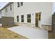 Concrete patio with an open door to the house, and light grey siding at 699 Sunstone Ln, Lawrenceville, GA 30043