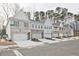 Street view of new townhomes with white garages and landscaping at 699 Sunstone Ln, Lawrenceville, GA 30043