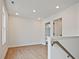 Bright upstairs landing area with natural light, wood flooring, and a view of the staircase at 699 Sunstone Ln, Lawrenceville, GA 30043