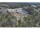 An aerial view showcases newly built townhomes in a community surrounded by lush greenery near the main road at 695 Sunstone Ln, Lawrenceville, GA 30043