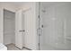 Bathroom featuring glass-enclosed shower and convenient linen closet with wire shelving at 695 Sunstone Ln, Lawrenceville, GA 30043