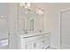 Bathroom with dual sink vanity, bright lighting, and a linen closet for storage at 695 Sunstone Ln, Lawrenceville, GA 30043