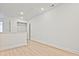 Bonus room with light wood flooring, bright white walls, storage, and access to attic at 695 Sunstone Ln, Lawrenceville, GA 30043