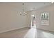 Dining area with modern chandelier, light walls and back door to the exterior at 695 Sunstone Ln, Lawrenceville, GA 30043